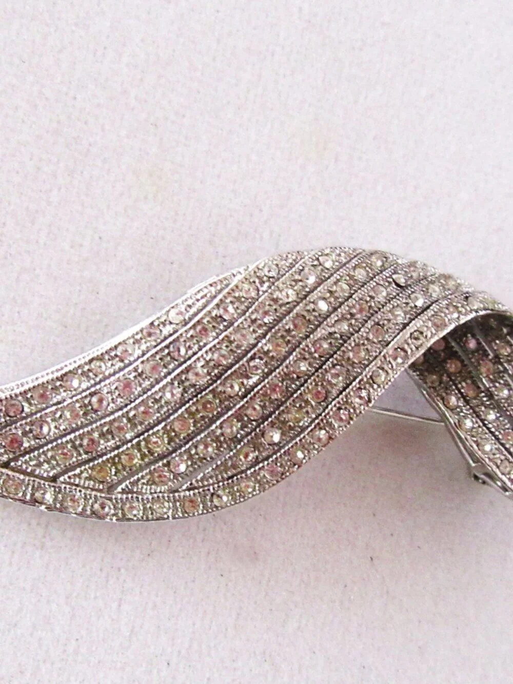 Clear pave rhinestone free form ribbon brooch in silver tone setting